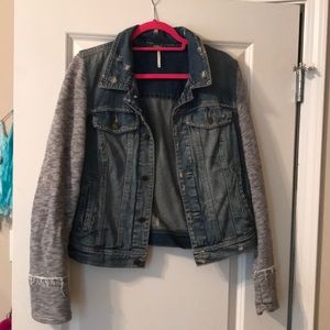 Denim jacket with sweat shirt sleeves.